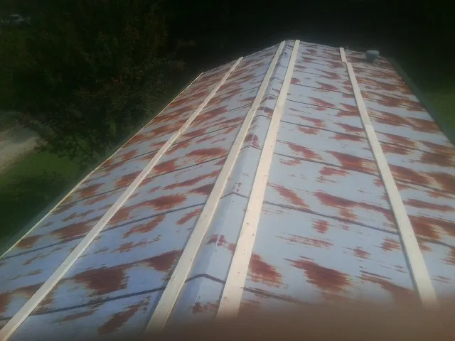 Rusted metal roof panels with new wood purlins before replacement — Storm Damage Roof Repair in Radiant by Roofing Brothers
